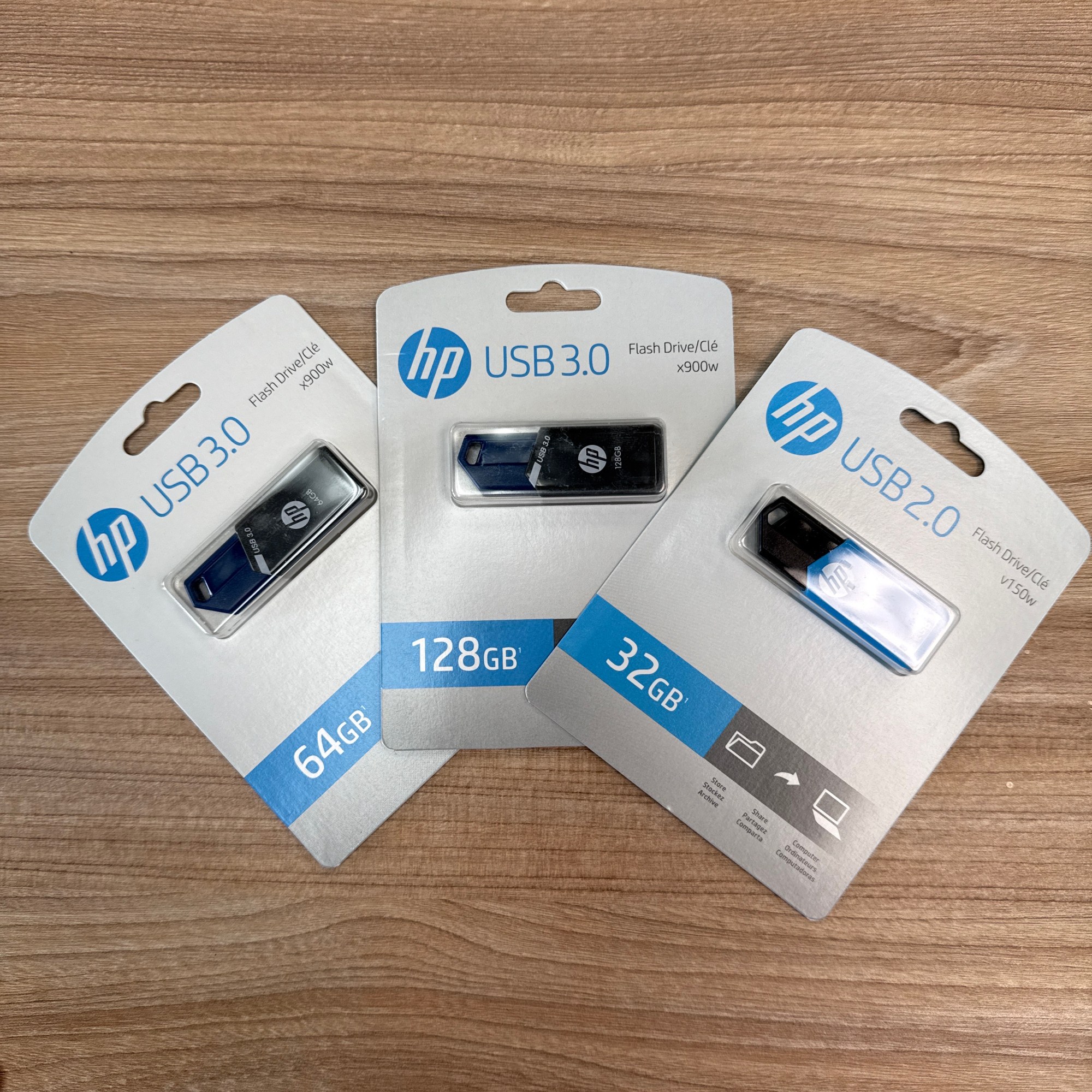 “HP USB flash drives in 64GB, 128GB, and 32GB capacities, featuring USB 3.0 and USB 2.0 models in retail packaging.”
