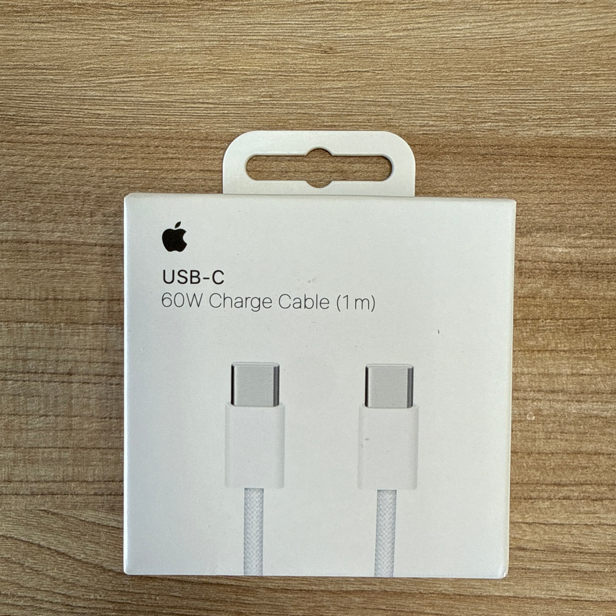 “Apple USB-C 60W charge cable, 1 meter, in white retail packaging.”